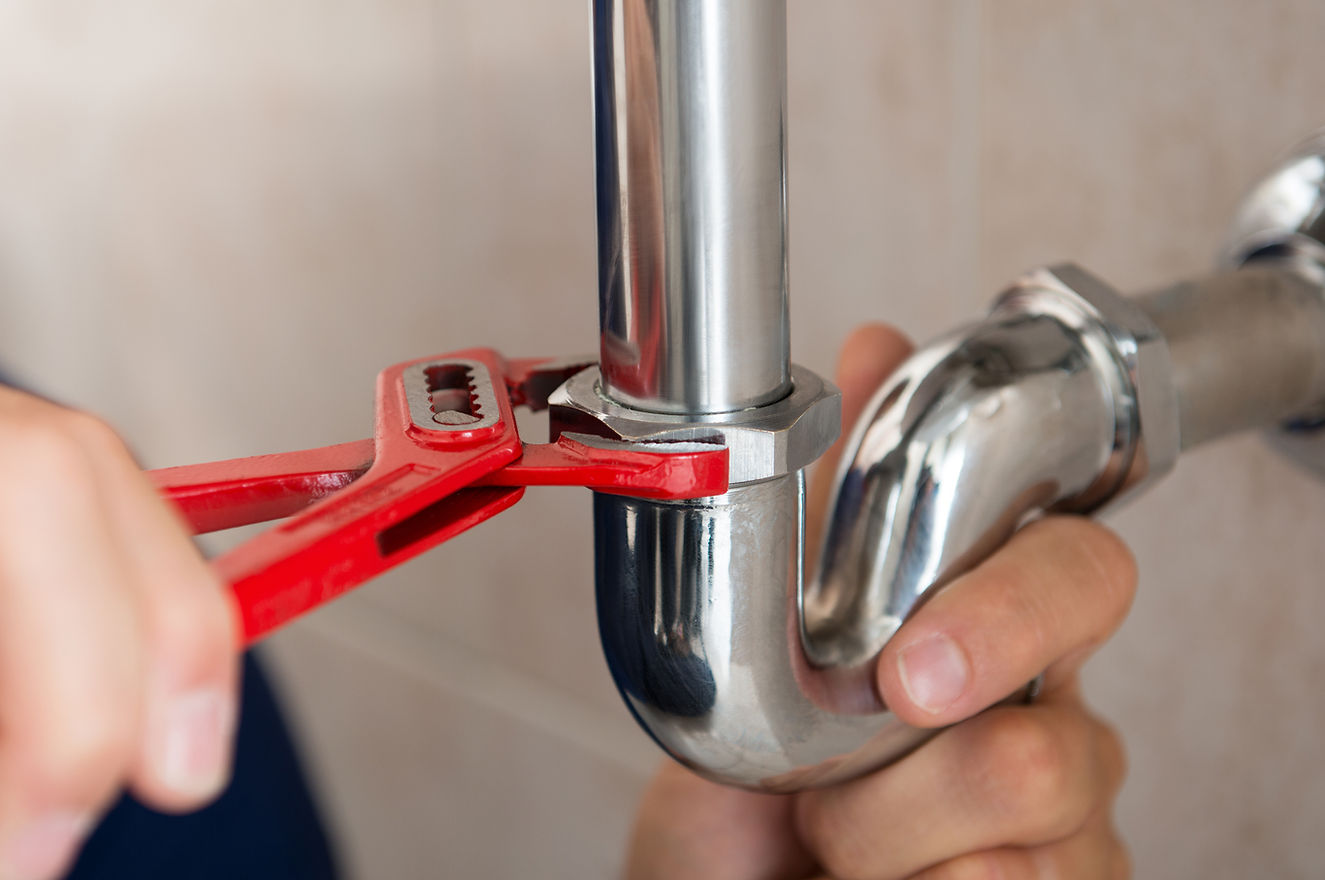 Professional plumbing repair work with precision tools